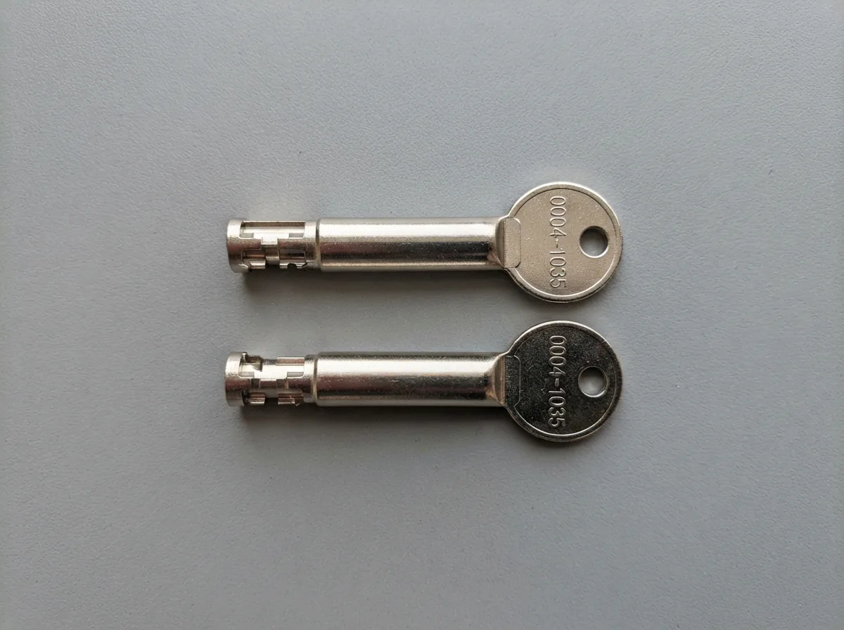 A set of two tubular replacement keys for US General toolboxes, clearly showing the key code and tubular design for lock identification.